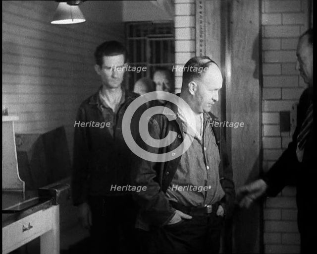 A group of Male Americans Civilians Wearing Prisoners Outfits Being Escorted Into a Room..., 1930. Creator: British Pathe Ltd.