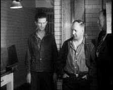A group of Male Americans Civilians Wearing Prisoners Outfits Being Escorted Into a Room..., 1930. Creator: British Pathe Ltd