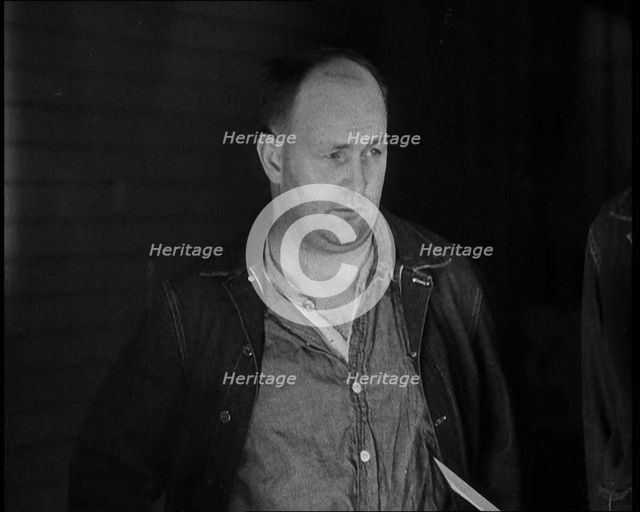 A group of Male Americans Civilians Wearing Prisoners Outfits Being Escorted Into a Room..., 1930. Creator: British Pathe Ltd.