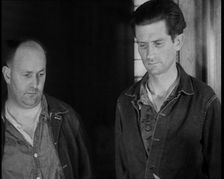 A group of Male Americans Civilians Wearing Prisoners Outfits Being Escorted Into a Room..., 1930. Creator: British Pathe Ltd