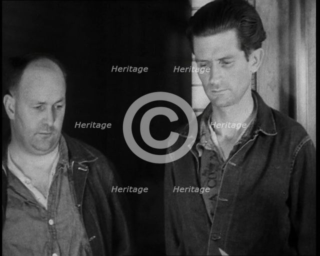 A group of Male Americans Civilians Wearing Prisoners Outfits Being Escorted Into a Room..., 1930. Creator: British Pathe Ltd.
