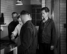 A group of Male Americans Civilians Wearing Prisoners Outfits Having Their Finger Prints..., 1930. Creator: British Pathe Ltd