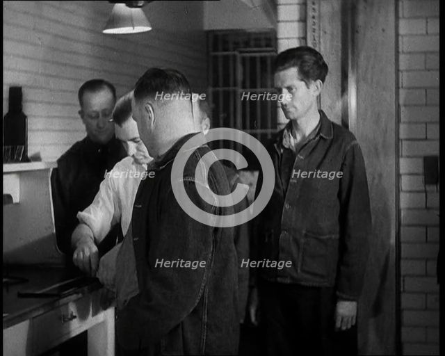 A group of Male Americans Civilians Wearing Prisoners Outfits Having Their Finger Prints..., 1930. Creator: British Pathe Ltd.