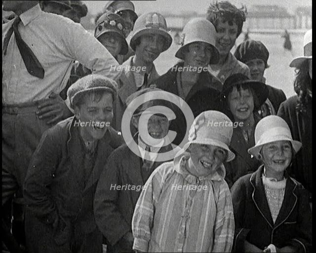 A Group of Male and Female Children Laughing as They Are Watching a Film Being Made, 1920s. Creator: British Pathe Ltd.