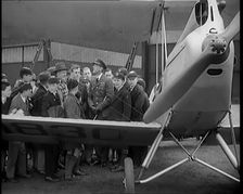 A Group of Male Children Standing Next To an RAF Officer and an Aeroplane, 1931. Creator: British Pathe Ltd