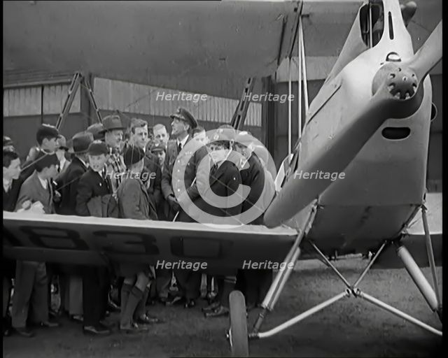 A Group of Male Children Standing Next To an RAF Officer and an Aeroplane, 1931. Creator: British Pathe Ltd.