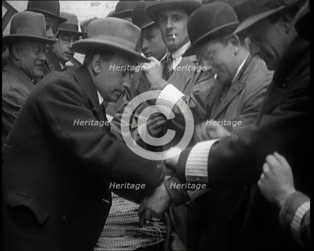 A Group of Male Civilians Volunteers Being Issued With White Arm Bands, 1926. Creator: British Pathe Ltd.