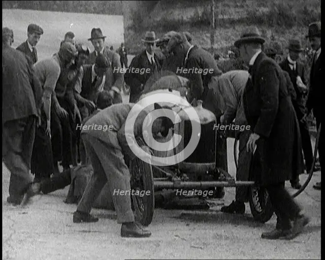 A Group of Male Civilians Working on a Car, 1924. Creator: British Pathe Ltd.