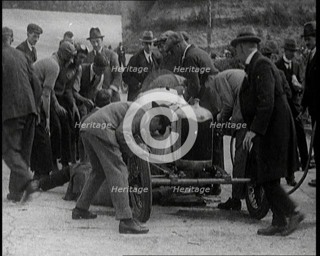 A Group of Male Civilians Working on a Car, 1924. Creator: British Pathe Ltd.