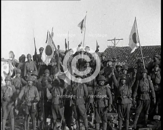 A Group of Male Japanese Soldiers, Many Waving Guns Aloft and Some With Japanese Flags..., 1937. Creator: British Pathe Ltd.