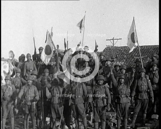 A Group of Male Japanese Soldiers, Many Waving Guns Aloft and Some With Japanese Flags..., 1937. Creator: British Pathe Ltd.