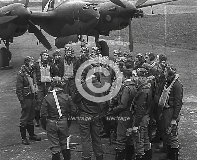 A Group of Male Pilots Talking in Front of an Aircraft, 1943-1944. Creator: British Pathe Ltd.