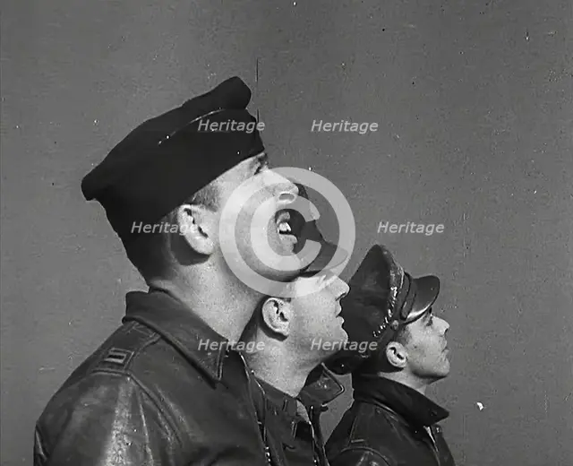 A Group of Male Pilots Watching Aircraft in the Sky, 1943-1944. Creator: British Pathe Ltd.