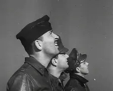 A Group of Male Pilots Watching Aircraft in the Sky, 1943-1944. Creator: British Pathe Ltd