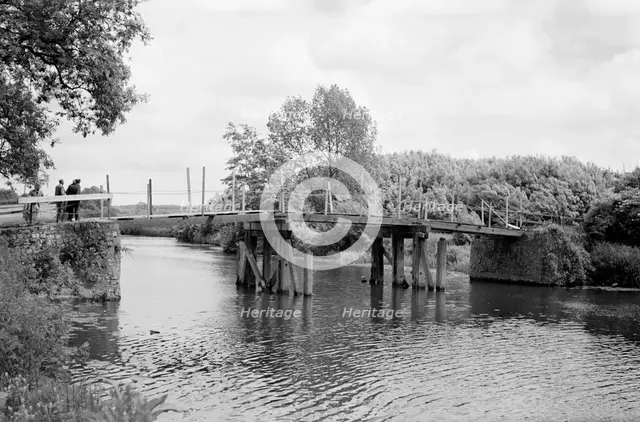 A group of men contemplate a footbridge over the River Medway at Barming, c1945-c1965. Artist: SW Rawlings