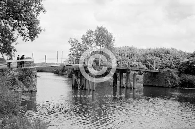 A group of men contemplate a footbridge over the River Medway at Barming, c1945-c1965. Artist: SW Rawlings