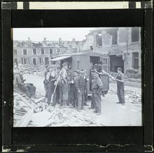 A group of men, possibly rescue workers, outside a tea van on a bomb damaged street, England, 1940-5 Creator: Norman Kingsley Harrison
