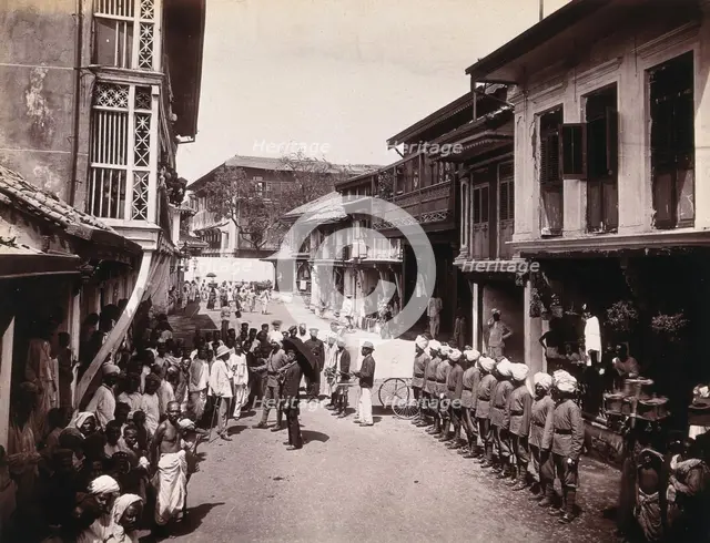 A group of officials making a visit to a house in Bombay, suspected of holding people with..., 1896. Creator: Unknown.