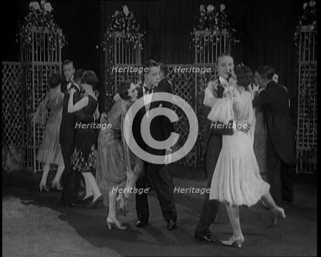 A Group of People Dancing the Charleston. One Female Civilian is Rubbing Her Legs is Pain, 1926. Creator: British Pathe Ltd.