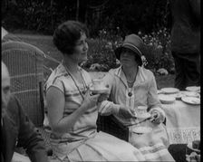 A Group of People Drinking Tea and Eating Cakes in the Garden, 1926. Creator: British Pathe Ltd