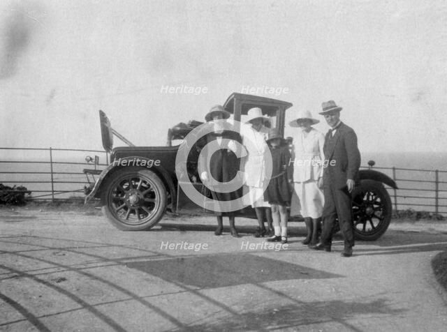 A group of people in front of their car at the seaside, c1920s(?). Artist: Unknown