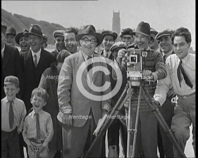 A Group of People Laughing as They Are Watch the Film Being Made from Behind a Camera, 1920s. Creator: British Pathe Ltd.