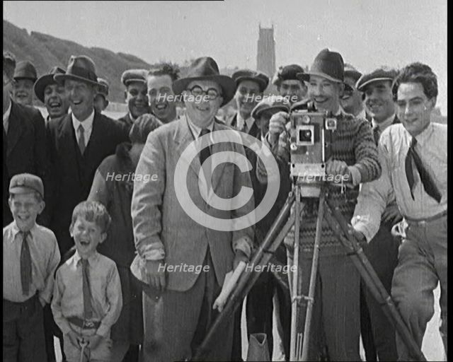 A Group of People Laughing as They Are Watch the Film Being Made from Behind a Camera, 1920s. Creator: British Pathe Ltd.