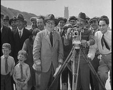 A Group of People Laughing as They Are Watch the Film Being Made from Behind a Camera, 1920s. Creator: British Pathe Ltd