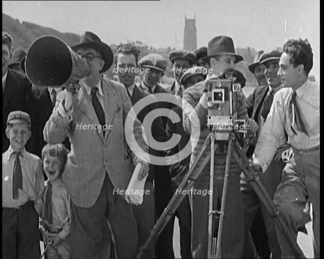 A Group of People Laughing as They Are Watch the Film Being Made from Behind a Camera, 1920s. Creator: British Pathe Ltd.
