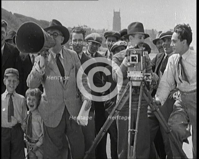 A Group of People Laughing as They Are Watch the Film Being Made from Behind a Camera, 1920s. Creator: British Pathe Ltd.