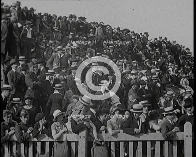 A Group of People Waving As Old Fashioned Looking Hot Air Balloons Are Taking Off the Ground, 1920s. Creator: British Pathe Ltd.