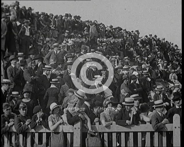 A Group of People Waving As Old Fashioned Looking Hot Air Balloons Are Taking Off the Ground, 1920s. Creator: British Pathe Ltd.