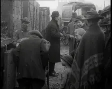 A Group of People Waiting To Receive a Measure of Coal, 1924. Creator: British Pathe Ltd
