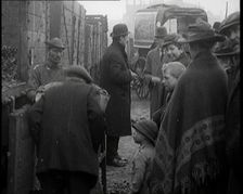 A Group of People Waiting To Receive a Measure of Coal, 1924. Creator: British Pathe Ltd