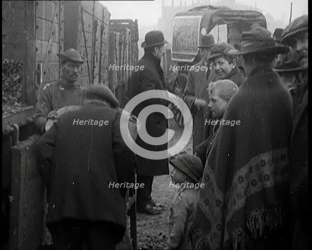 A Group of People Waiting To Receive a Measure of Coal, 1924. Creator: British Pathe Ltd.