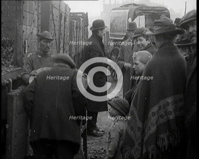 A Group of People Waiting To Receive a Measure of Coal, 1924. Creator: British Pathe Ltd.