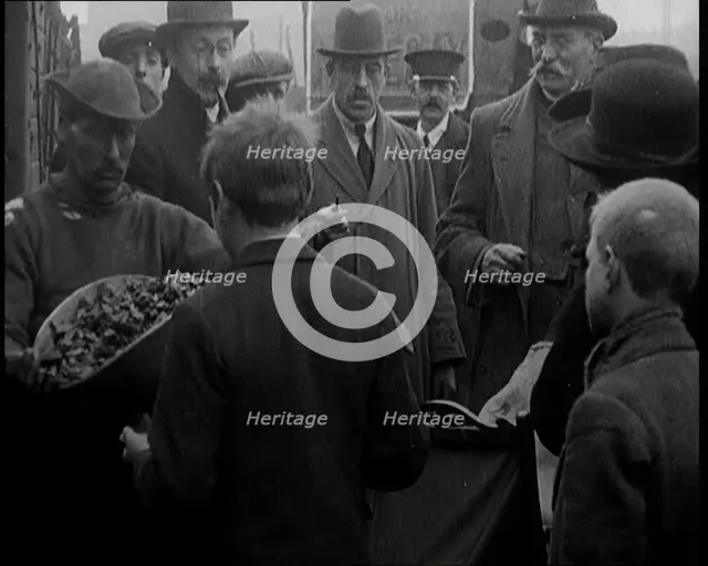 A Group of People Waiting To Receive a Measure of Coal, 1924. Creator: British Pathe Ltd.