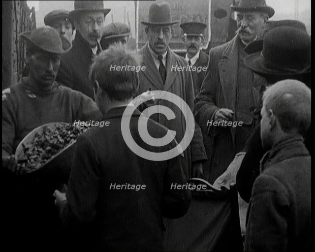A Group of People Waiting To Receive a Measure of Coal, 1924. Creator: British Pathe Ltd.