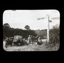 A group of people with two motorcycles and a sidecar having a picnic at the side of..., 1926-1939. Creator: Norman Kingsley Harrison
