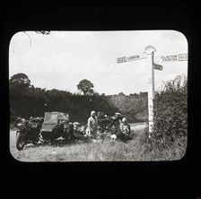 A group of people with two motorcycles and a sidecar having a picnic at the side of..., 1926-1939. Creator: Norman Kingsley Harrison