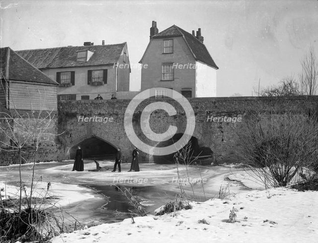 A group skating on the frozen River Thames, Abingdon Bridge, Abingdon, Oxfordshire, c1860-c1922. Artist: Henry Taunt