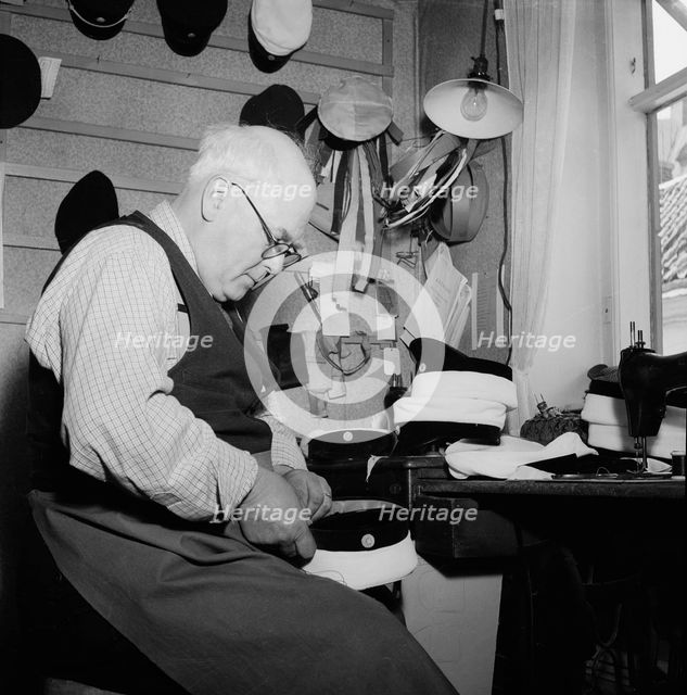 A hatter making a cap, Landskrona, Sweden, 1949.  Creator: Unknown.