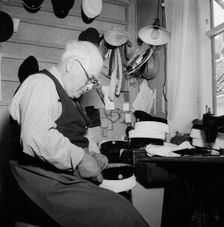 A hatter making a cap, Landskrona, Sweden, 1949. Creator: Unknown