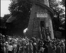 A Helter Skelter Fairground Ride in a Park With a Man at the Entrance With a Megaphone..., 1939. Creator: British Pathe Ltd