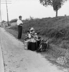 A hitchhiking family waiting along the highway in Macon, Georgia, 1937. Creator: Dorothea Lange