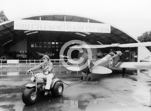 A Honda all terrain cycle pulling a vintage biplane, 1982. Artist: Unknown