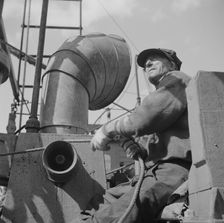 A hoister unloading fish at Fulton fish market, New York, 1943. Creator: Gordon Parks