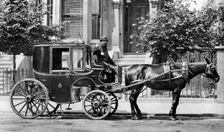 A horse-drawn carriage, London, 1926-1927