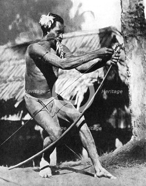 A huntsman stringing his bow, 1936.Artist: Wide World Photos