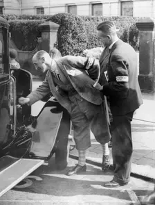 A judge inspecting a car at the Southport Rally, 1928